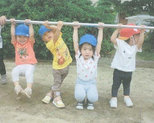 友達と鉄棒を楽しむTちゃん(左端)。